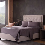 Malouf classic cotton sheet set with smooth, crisp white sheets and pillowcases shown on a neatly made bed.