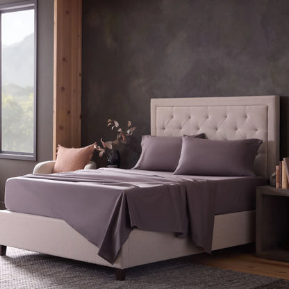 Malouf classic cotton sheet set with smooth, crisp white sheets and pillowcases shown on a neatly made bed.