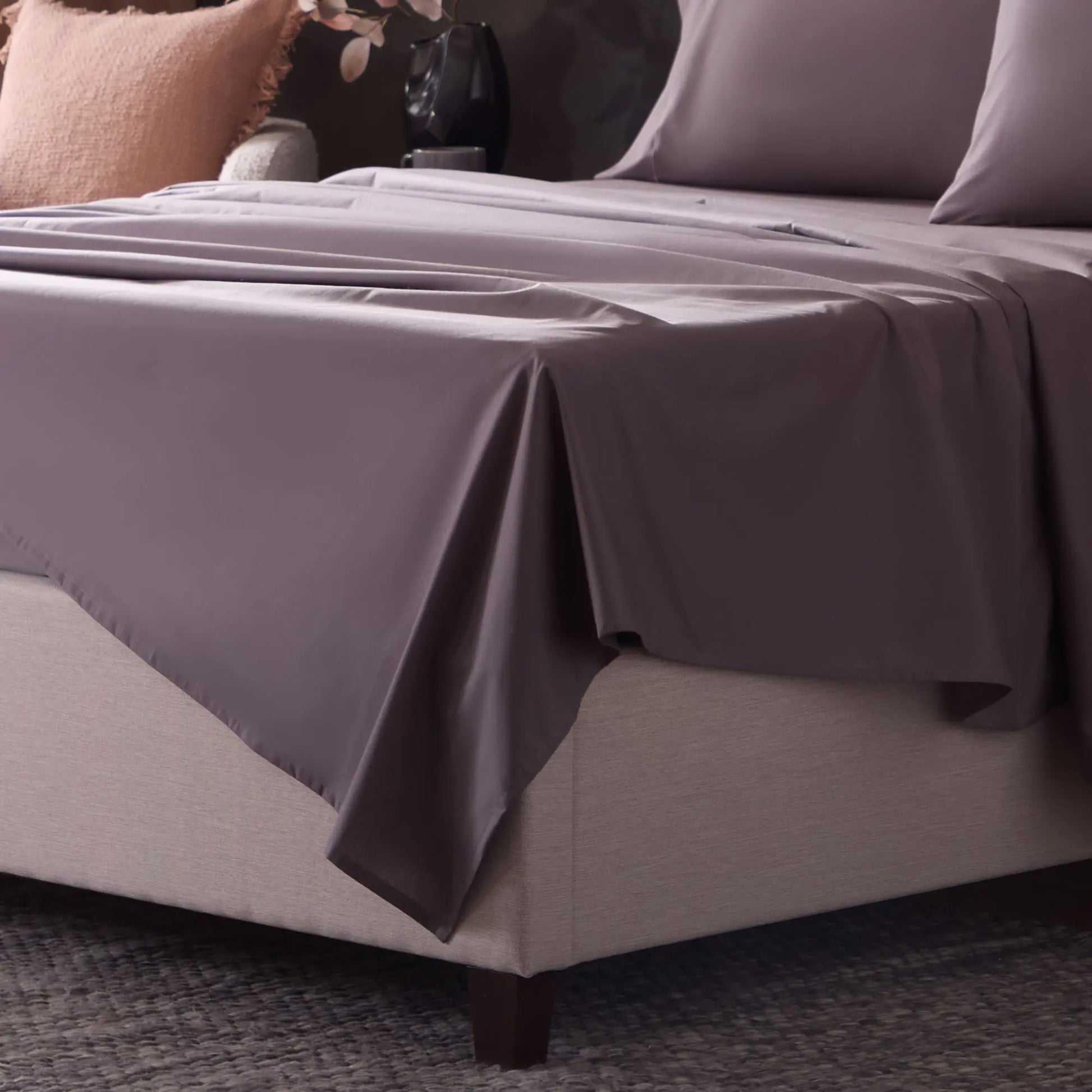 Close-up of Malouf classic cotton sheet set with embroidered corner detail, showing soft, smooth fabric and tailored stitching.