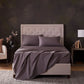 Malouf classic cotton sheet set with smooth, white bedding, including fitted and flat sheets, and pillowcases for a cozy sleep.