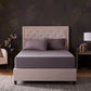 Malouf classic cotton sheet set with neatly tucked, straight sheets showing soft, breathable fabric and smooth texture.