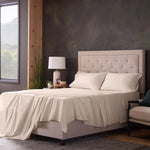 Malouf classic cotton sheet set with soft, crisp white sheets and matching pillowcases on a neatly made bed.