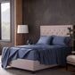 Malouf classic cotton sheet set draped on bed showing soft, smooth white sheets and pillowcases for comfortable sleep.