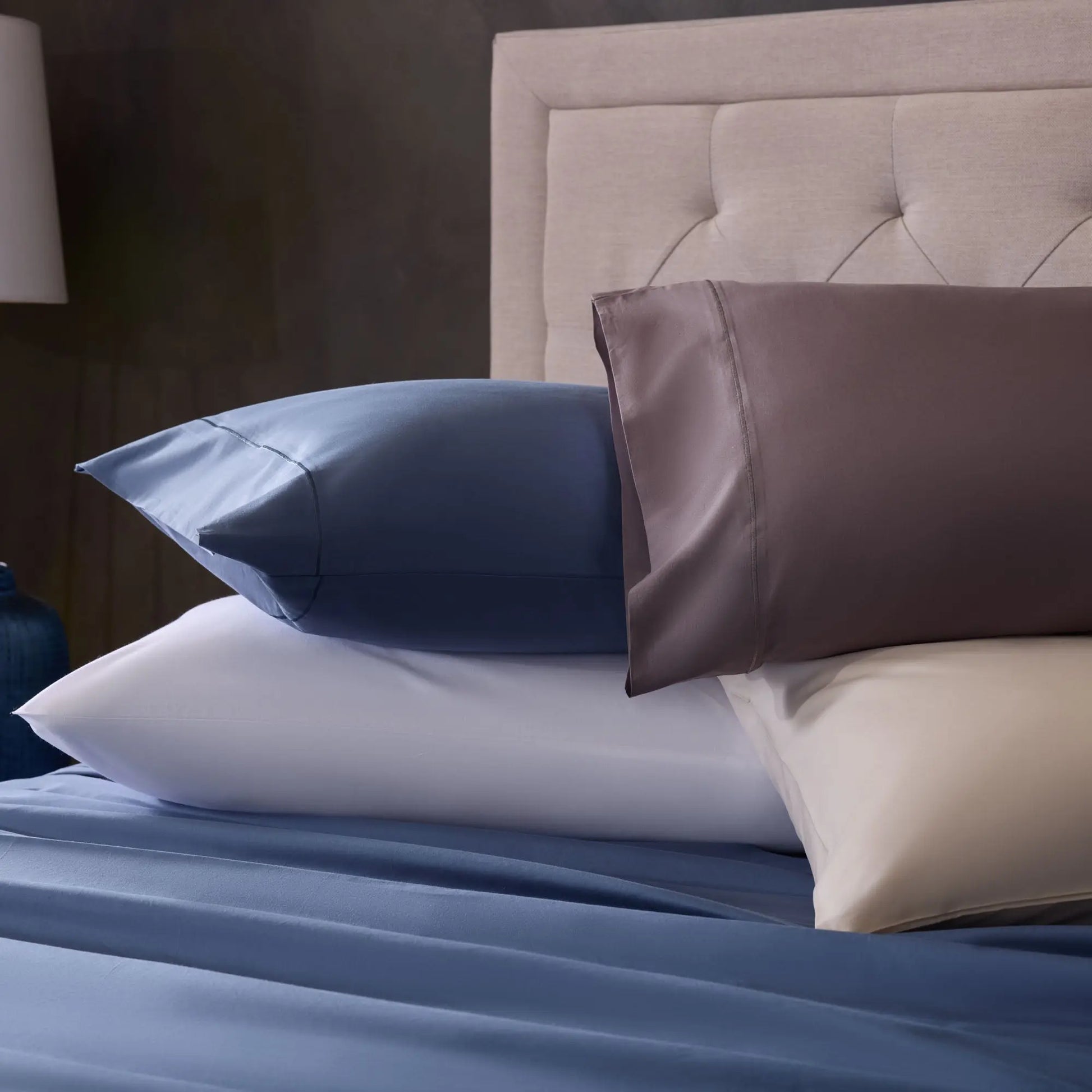Set of Malouf classic cotton sheet set in various colors, featuring soft, breathable fabric and a smooth, comfortable texture.