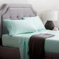 Malouf botanical sheet set made with TENCEL Lyocell fiber, showing soft, breathable fabric in a close-up view.