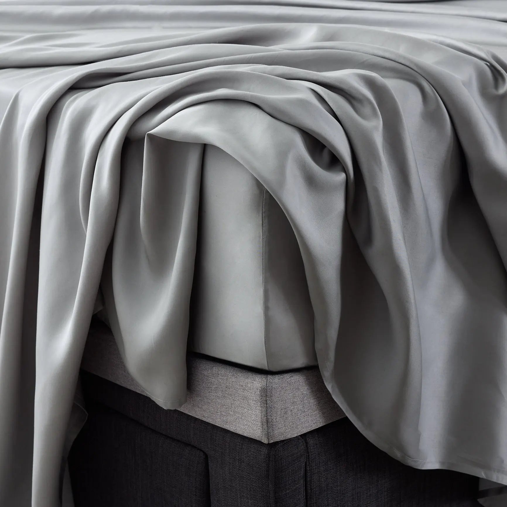 Close-up of Malouf botanical sheet set made with TENCEL Lyocell fiber, showcasing soft, smooth fabric and detailed corner stitching.