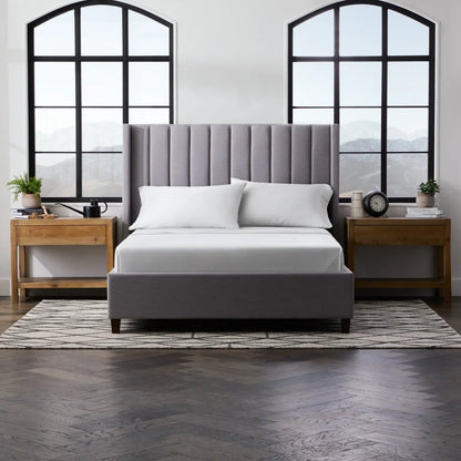 Smooth bamboo rayon sheet set by Malouf, showing soft, light gray sheets with a neatly folded top sheet and matching pillowcases.