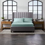 Malouf smooth bamboo rayon sheet set in ash color, showing soft, lightweight bedding with neatly folded sheets and pillowcases.