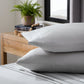 Smooth bamboo rayon sheet set by Malouf featuring soft, lightweight, ash-colored bed sheets with a neatly made bed.