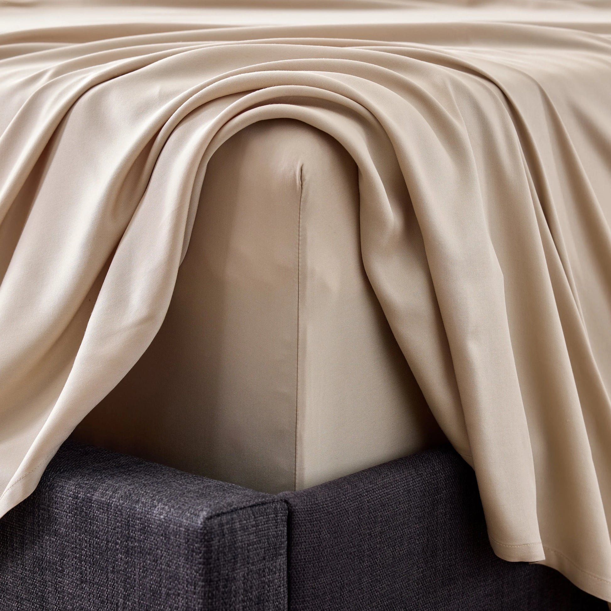 Close-up of smooth bamboo rayon sheet set by Malouf, showcasing soft, breathable fabric with detailed corner stitching.