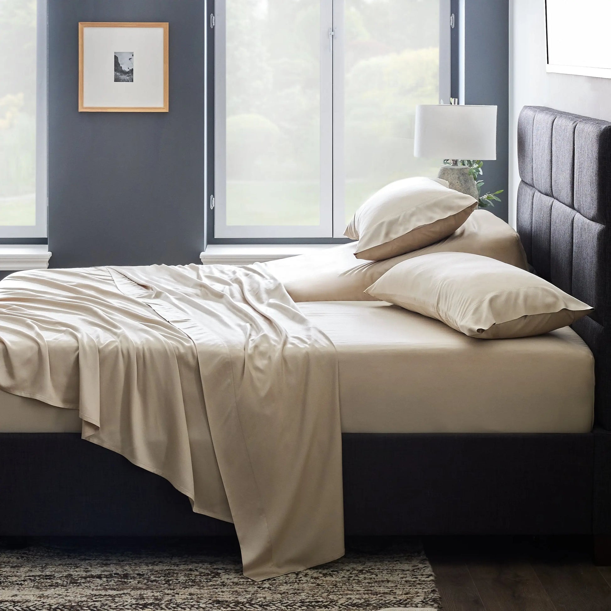 Malouf smooth bamboo rayon sheet set with fitted and flat sheets in neutral tones, showcasing soft, breathable bedding for a cozy sleep.