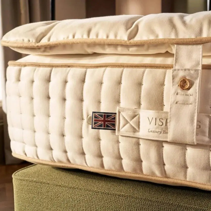Vispring Opulence mattress topper with plush fabric and luxurious padding, designed to enhance comfort and support.