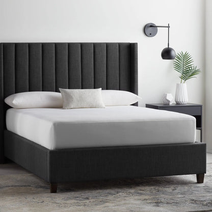 Malouf Five Sided and OmniPhase mattress protector on a bed, showing its fitted design and protective fabric for bedding.