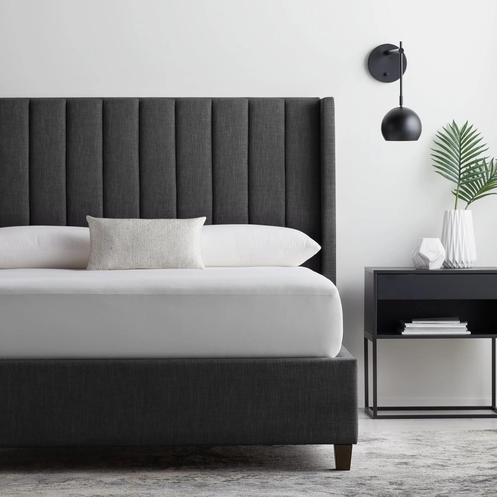 Malouf Five Sided and OmniPhase mattress protector on a bed, showing its fitted design and protective fabric for mattress coverage.