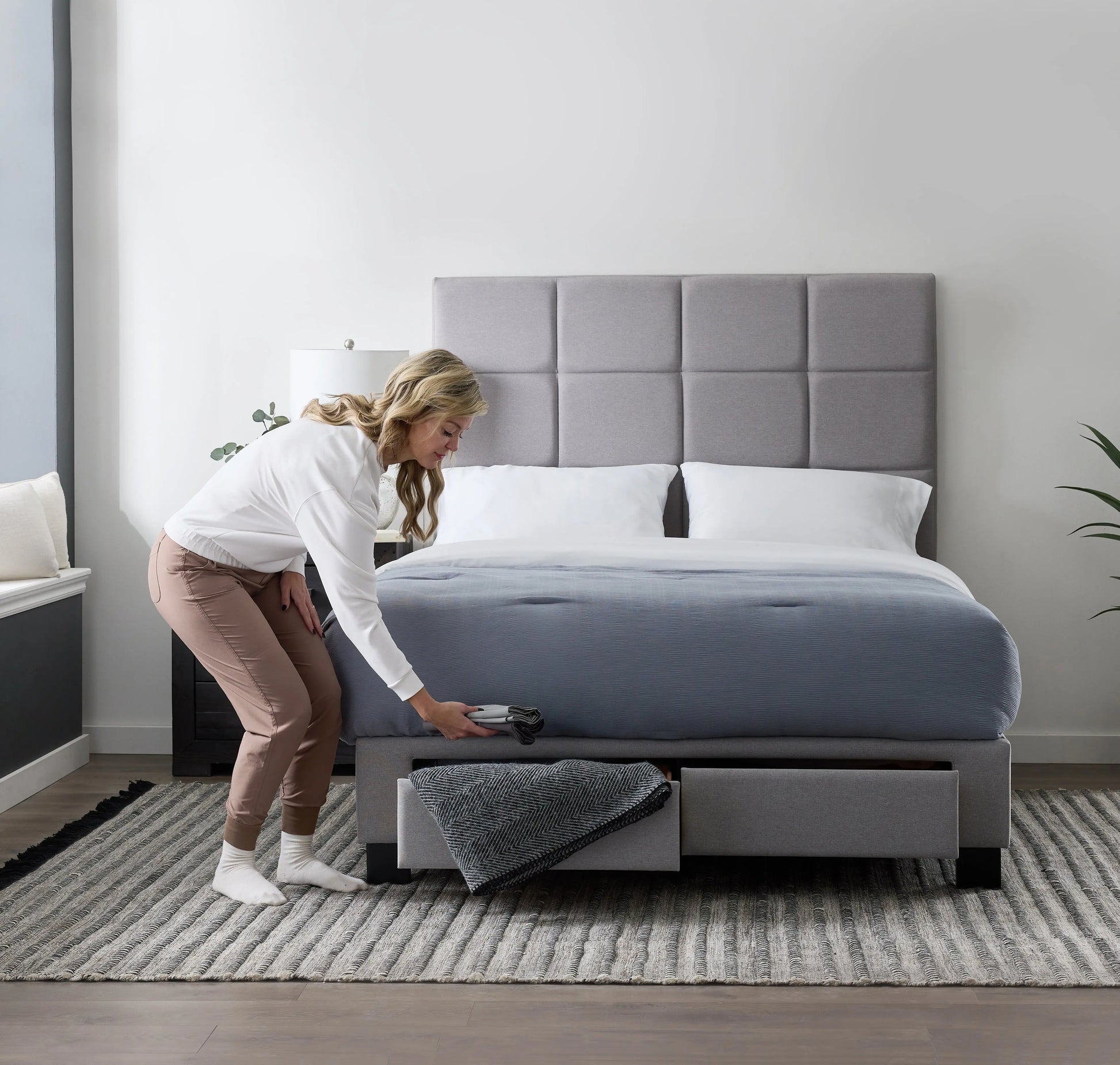 Malouf Duncan platform bed frame with a sleek design, featuring a straight drawer for storage, shown in a modern bedroom setting.