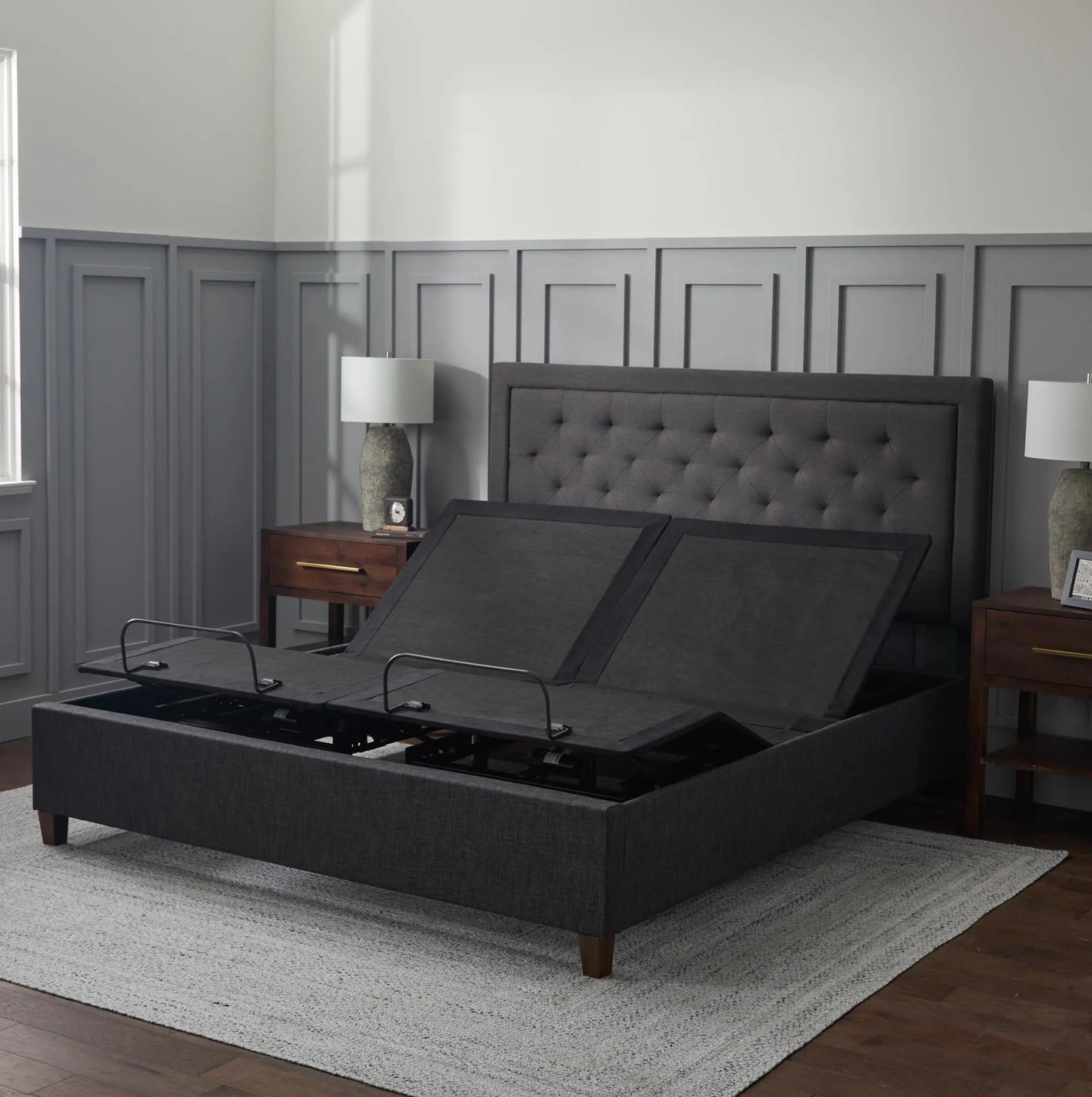 Malouf E255 adjustable bed base with remote control, black metal frame, and adjustable head and foot sections.