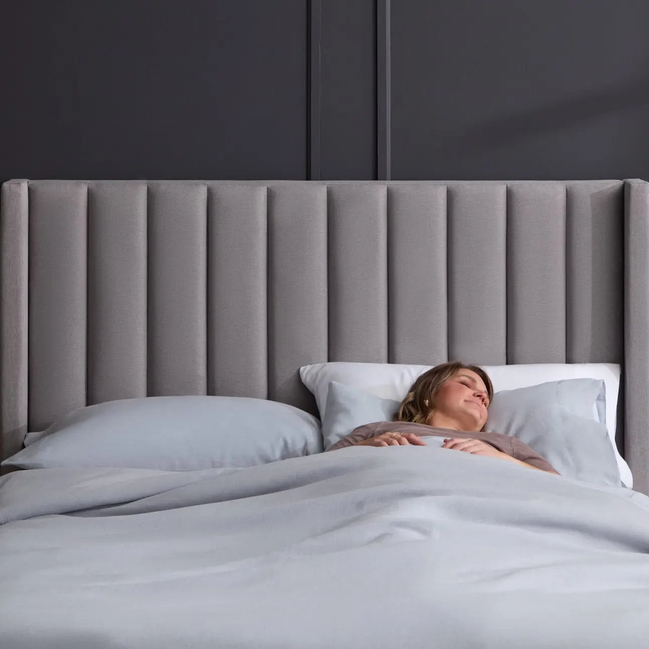 Blackwell headboard by Malouf featuring a sleek, modern design with a wide, straight-edged profile in black fabric.