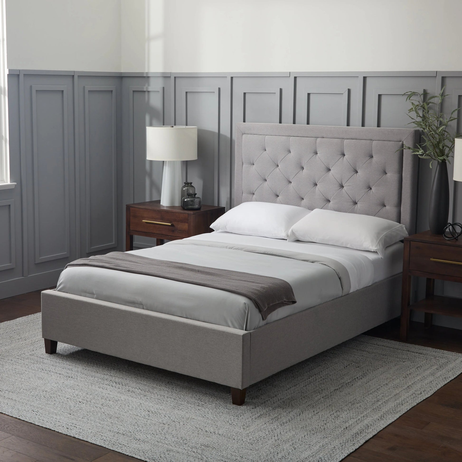 Malouf Eastman platform bed frame with a sleek, modern design and sturdy construction, shown with a headboard panel in the image.