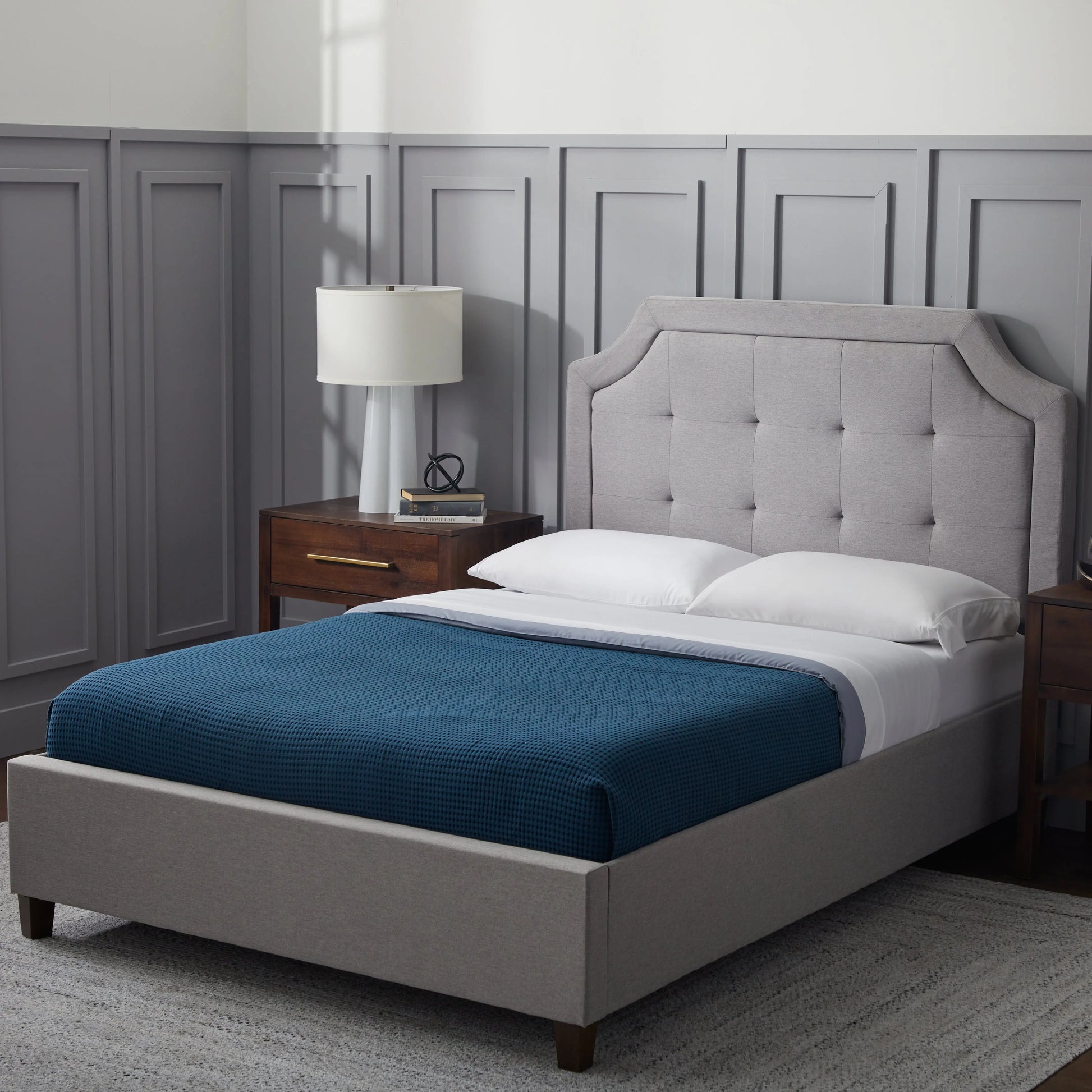 Malouf Carlisle headboard with a classic design, upholstered in soft fabric, attached to a bed frame for a stylish bedroom look.