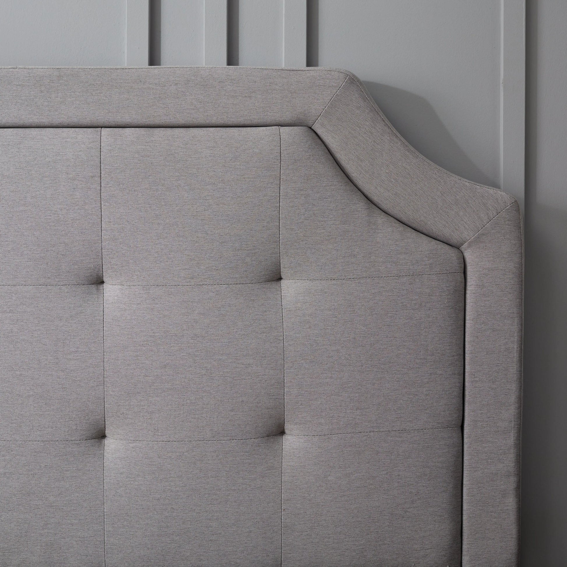 Close-up of the Malouf Carlisle Headboard showcasing its detailed corner design and elegant fabric upholstery.