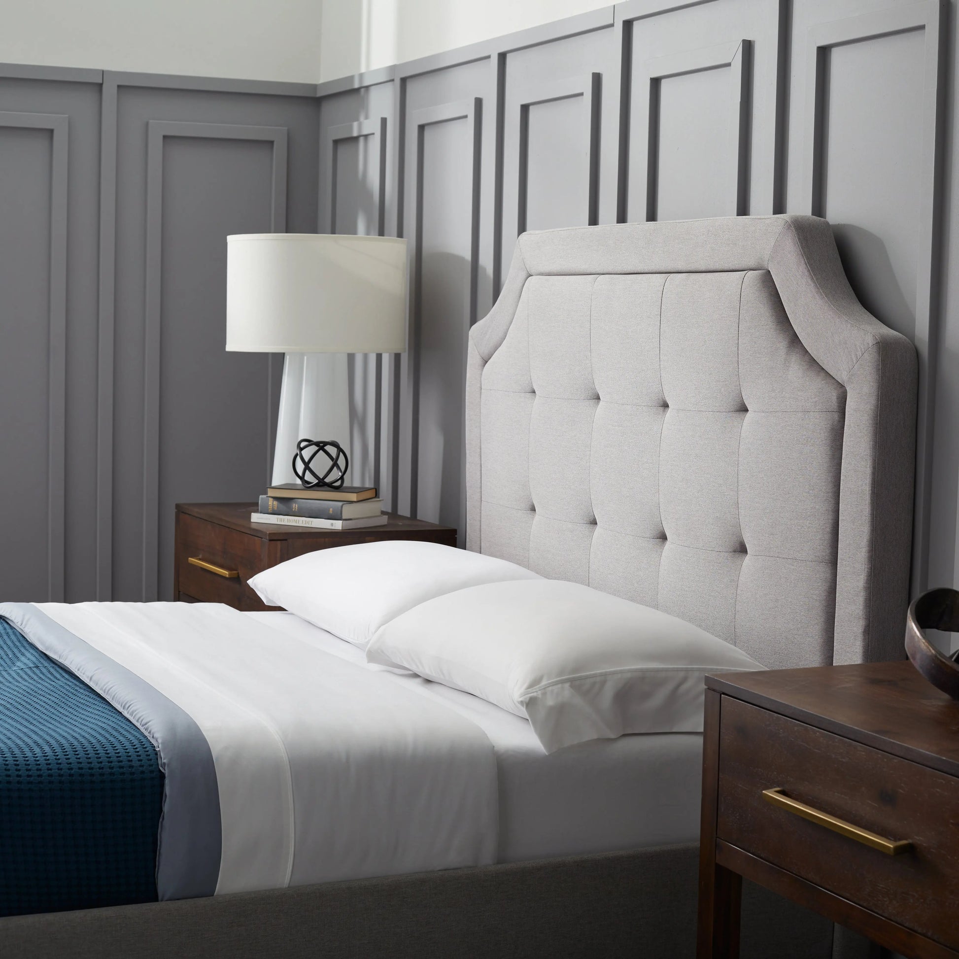 Malouf Carlisle headboard in a neutral fabric with a modern design, shown in a side profile view.