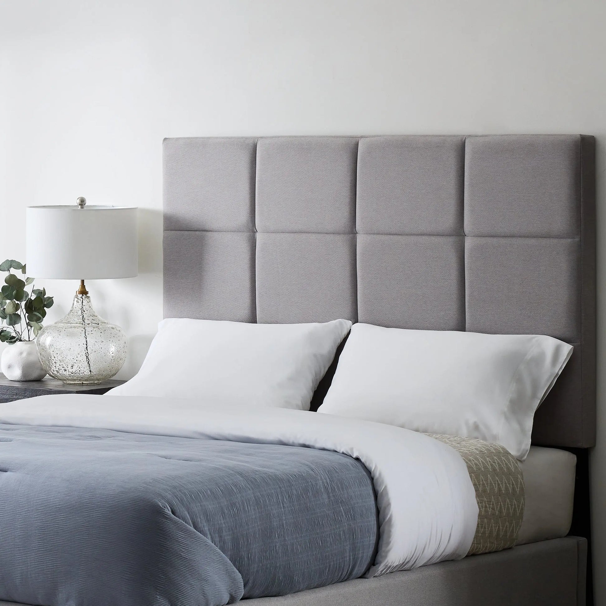 Malouf Scoresby headboard in neutral fabric with plush padding and wooden legs, designed for modern bedroom decor.