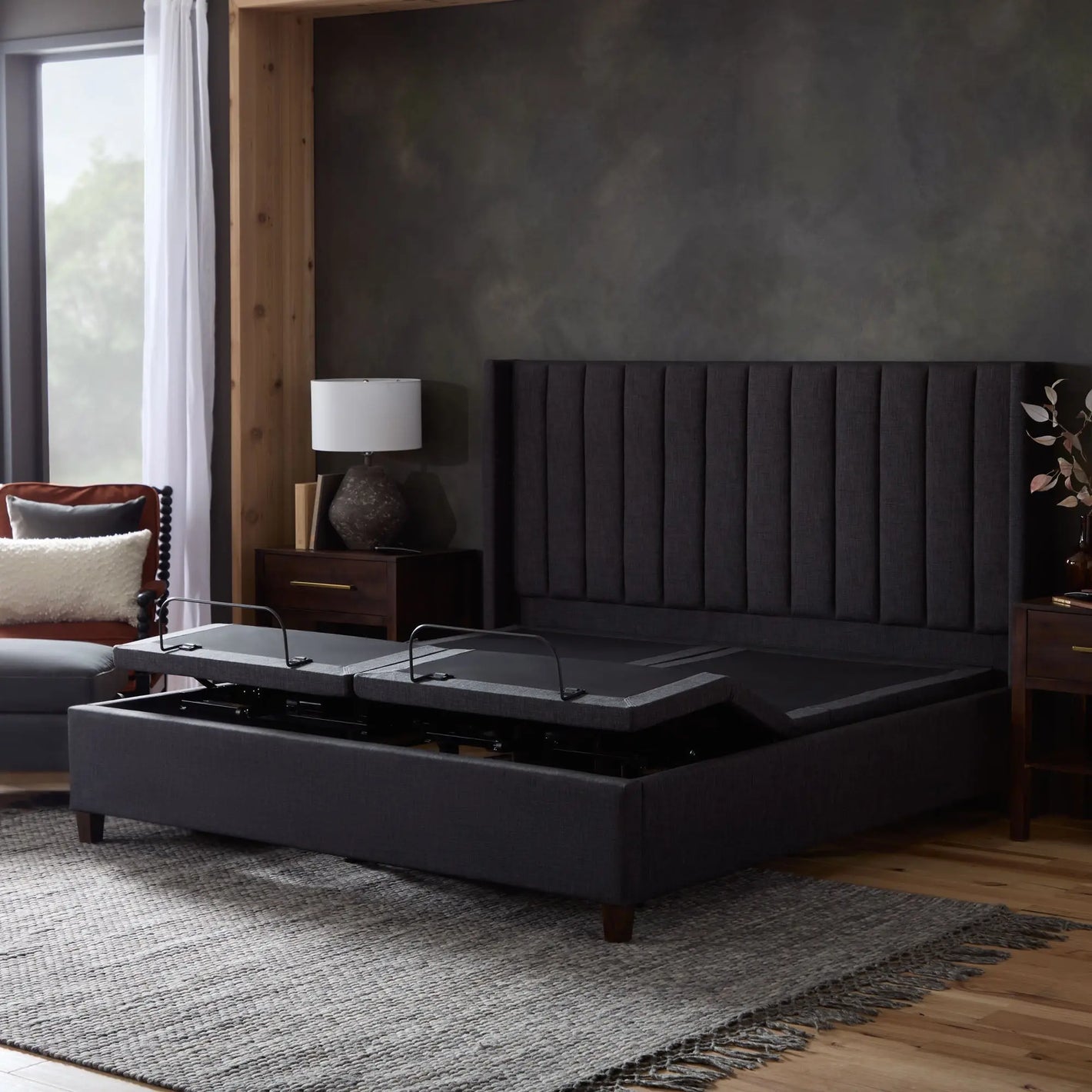 Malouf S655 adjustable base shown with raised foot sections on both sides, featuring a sleek black finish and remote control.