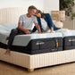 Split king TEMPUR-LuxeAdapt mattress by Tempur-Pedic with plush, undressed fabric cover, shown in a bedroom setting.