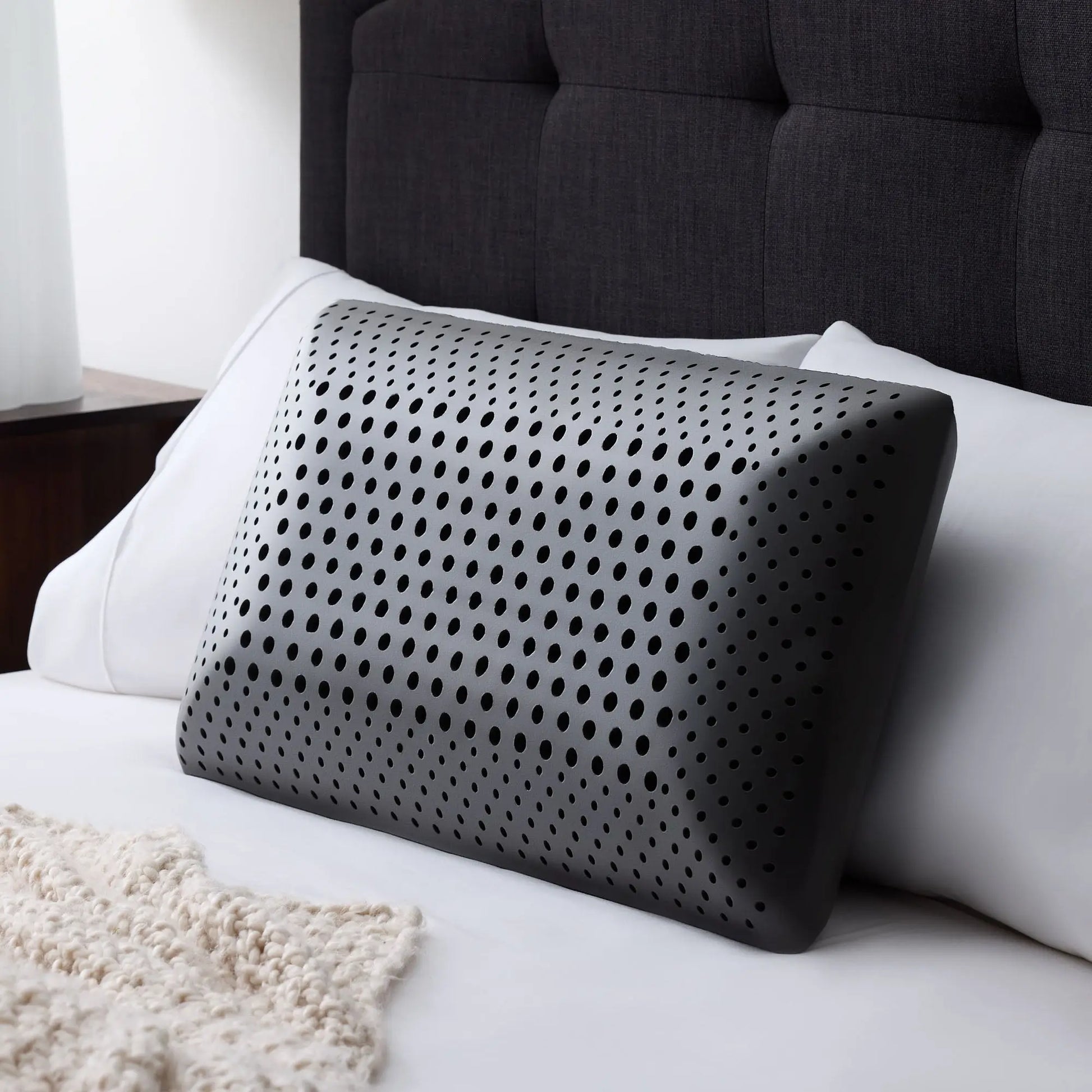 Malouf Zoned ActiveDough Pillow with bamboo charcoal cover, showing its ergonomic shape and plush surface for comfortable sleep.