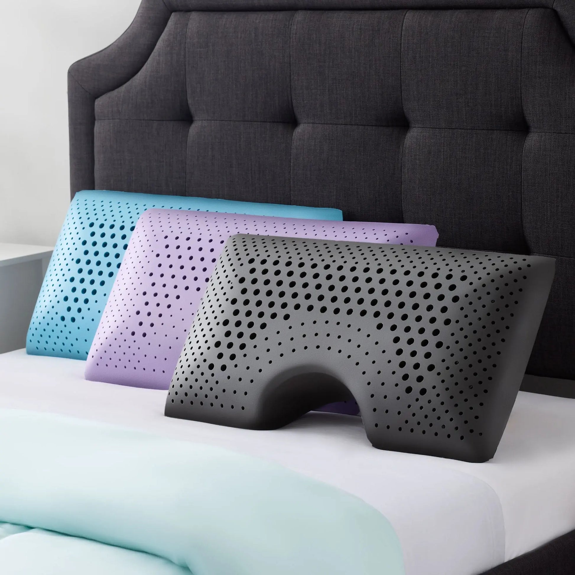 Malouf Shoulder Zoned Dough Pillow with lavender cover, showing the ergonomic design and plush surface for comfortable sleep.