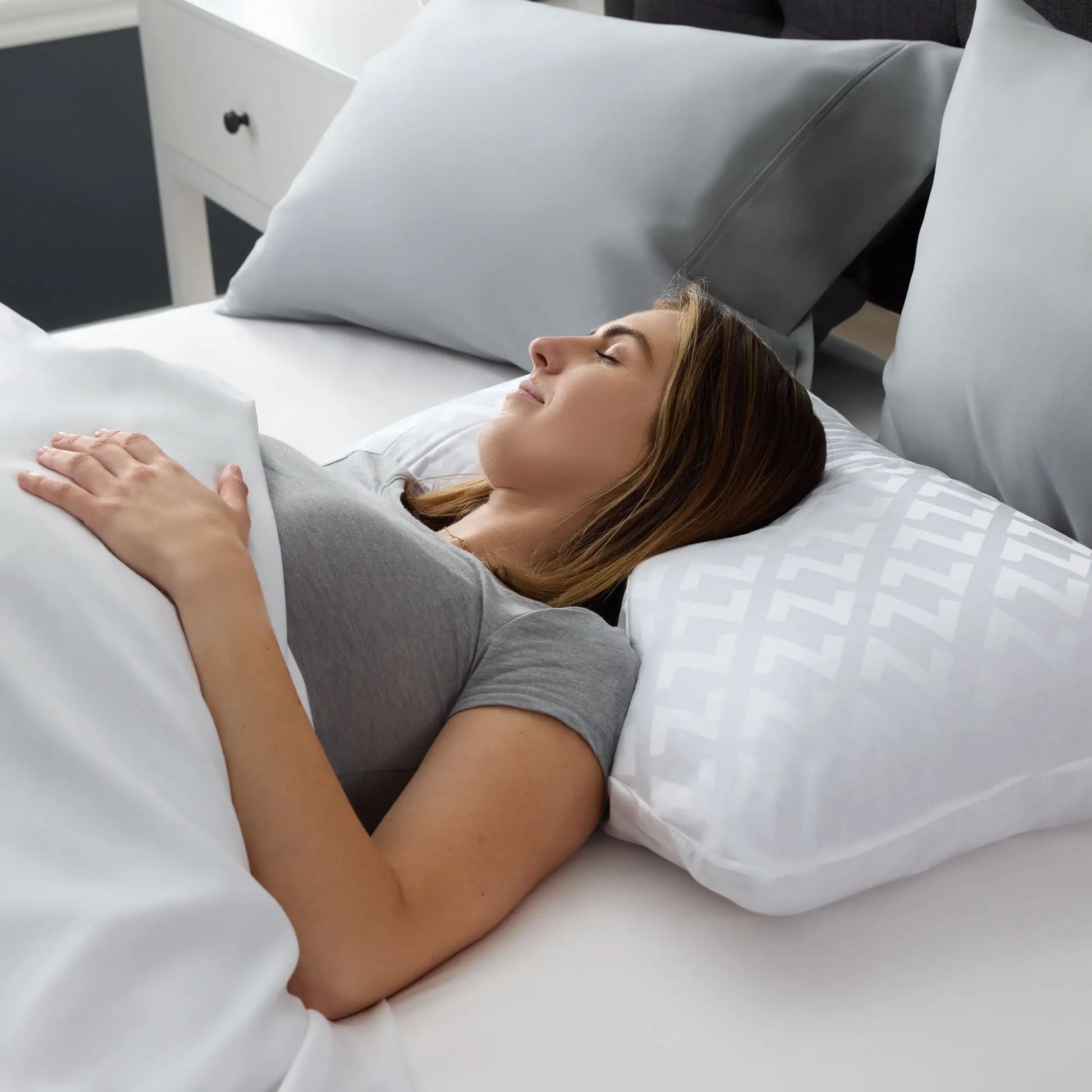 Malouf Shoulder Zoned Dough Pillow with lavender cover, showing its ergonomic design and plush memory foam construction.