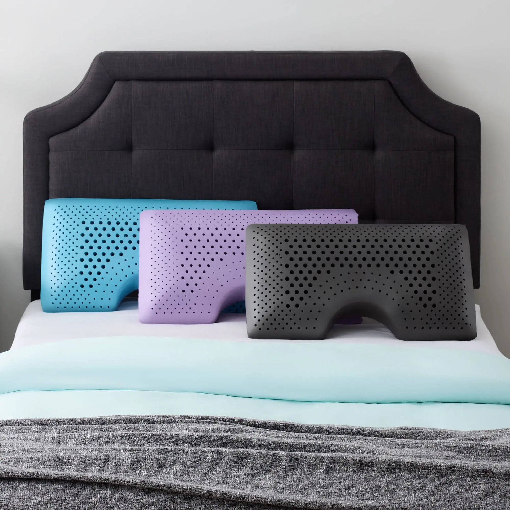 Malouf shoulder zoned dough pillow with lavender cover, showing ergonomic design and plush, supportive surface for comfortable sleep.