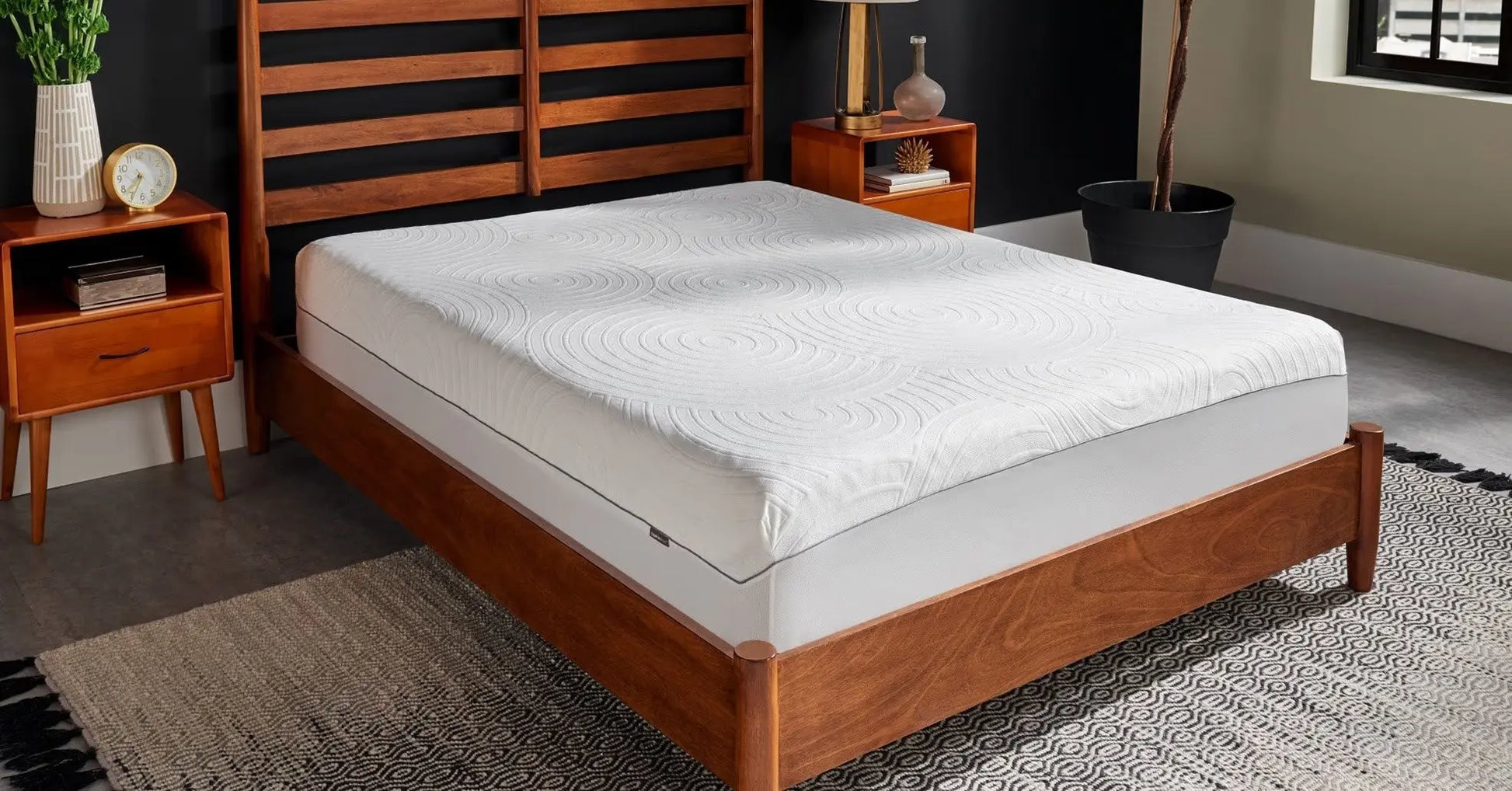 Tempur-Pedic TEMPUR-Protect mattress protector covering a bed, showcasing its snug fit and soft fabric for protection and comfort.