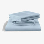 Malouf classic cotton sheet set with smooth, white Egyptian cotton sheets and matching pillowcases on a neatly made bed.