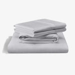 Malouf Classic Cotton Sheet Set in silver mist color, showing smooth, soft cotton bedsheets and pillowcases on a neatly made bed.