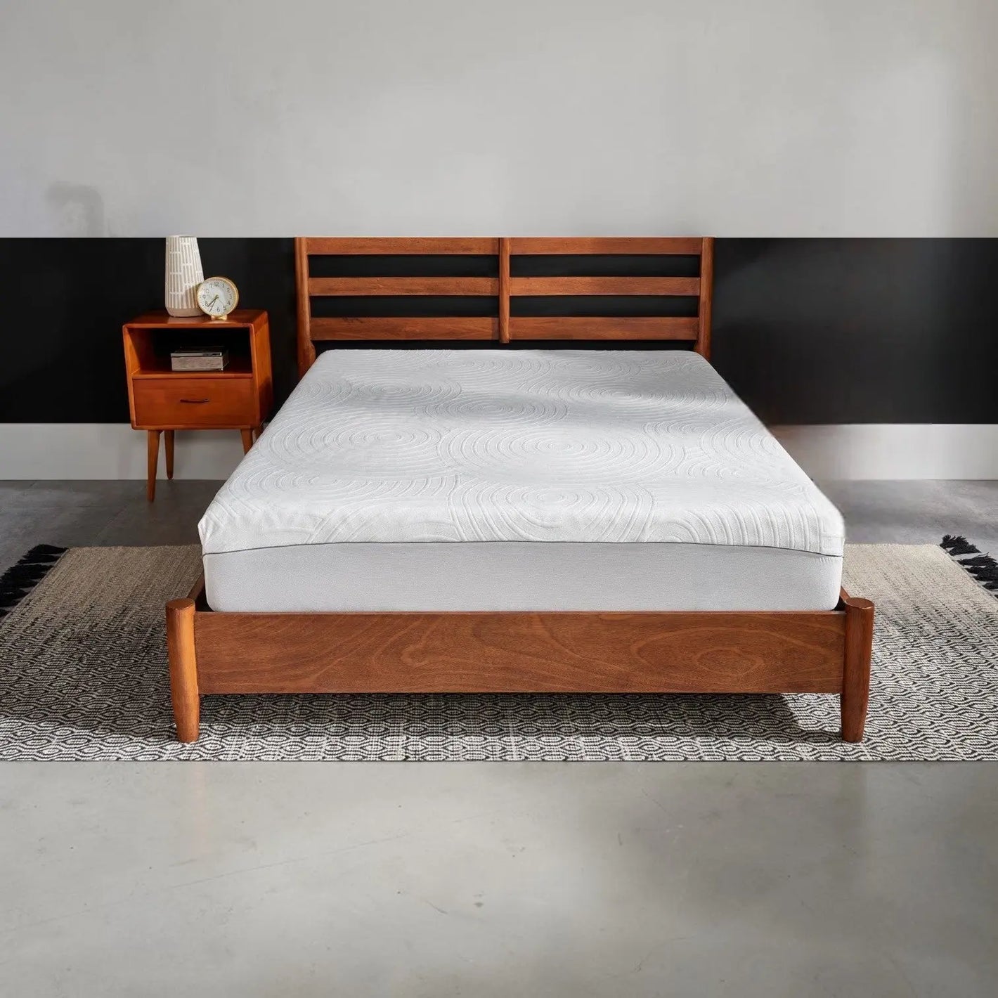 Tempur-Pedic TEMPUR-Protect mattress protector shown on a bed, transparent with fitted edges for full mattress coverage.