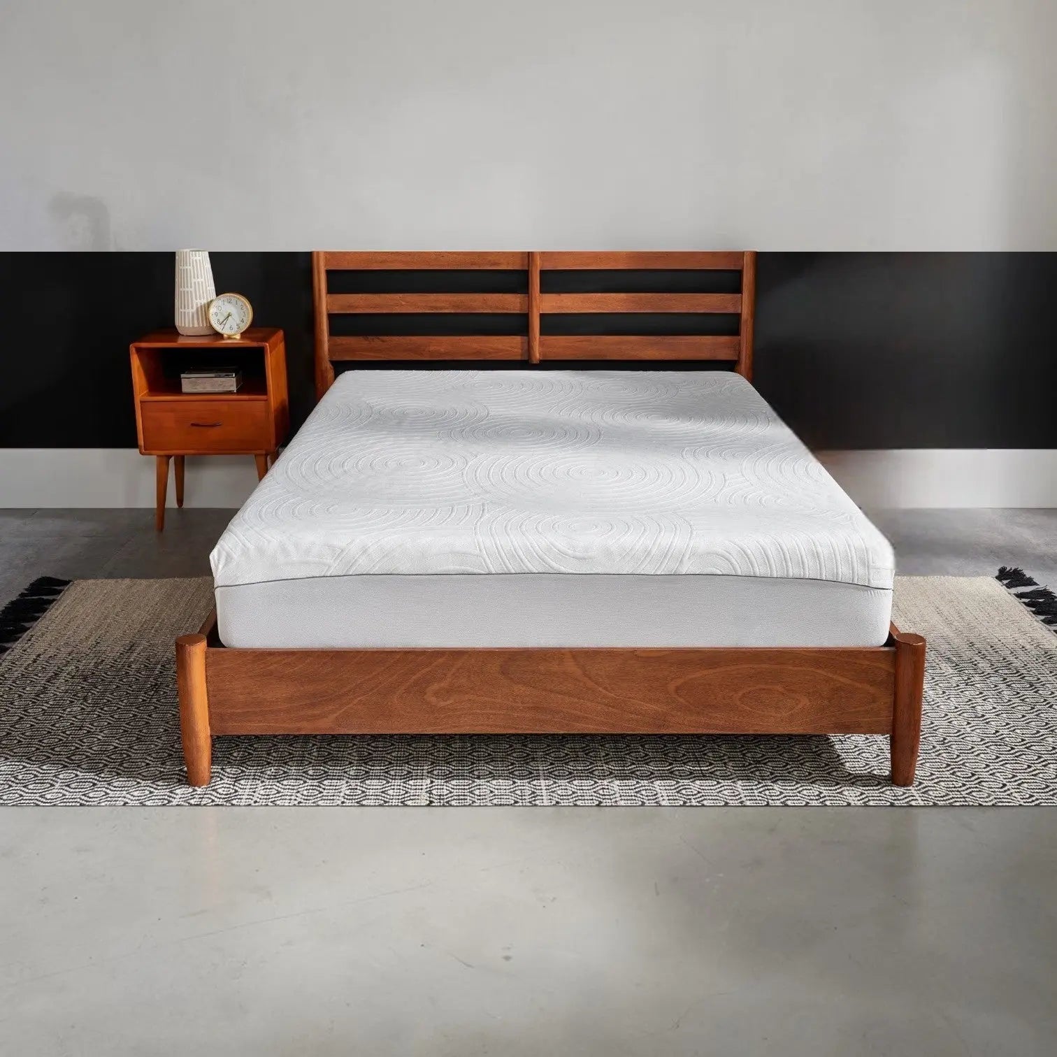 Tempur-Pedic TEMPUR-Protect mattress protector shown on a bed, transparent with fitted edges for full mattress coverage.